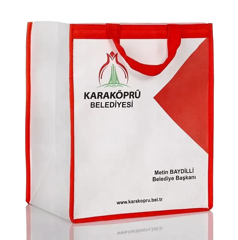 promosyon beyaz tela çanta, kırmızı biyeli, sap ve belediye logosu baskılı